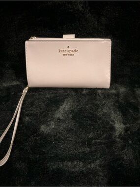 kate spade pale pink wristlet wallet with gold logo